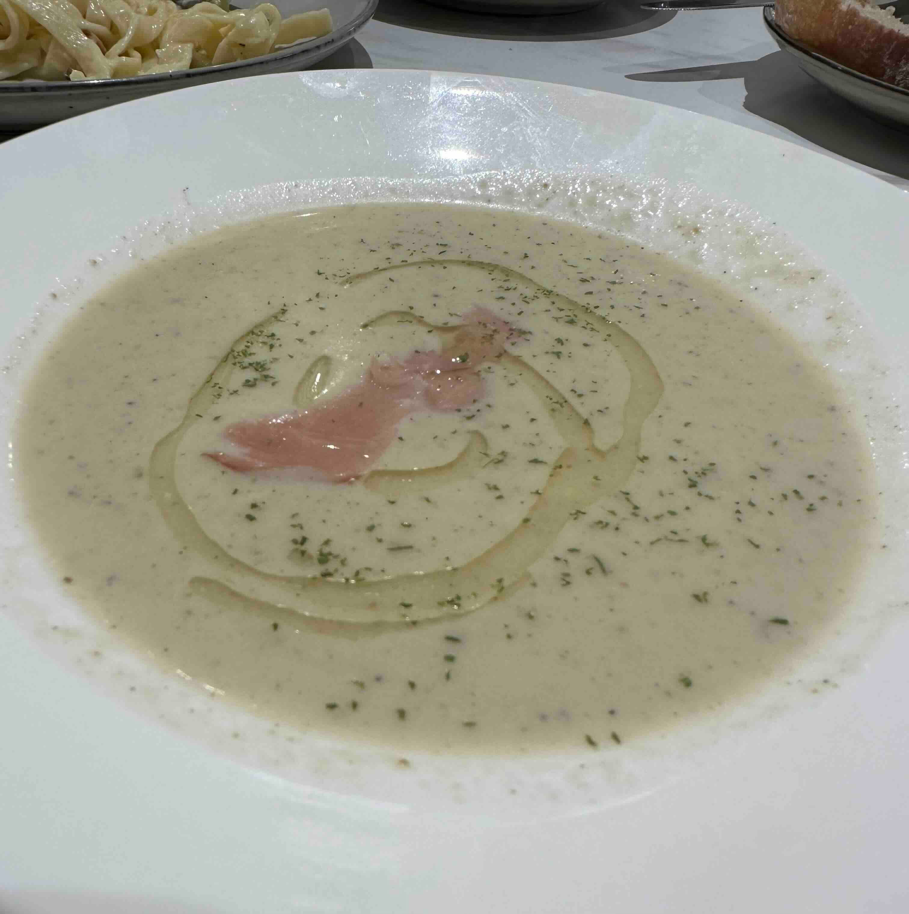 Cream soup with prosciutto and herb oil